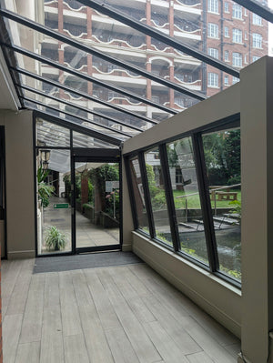 A room with a glass roof and a wooden floor