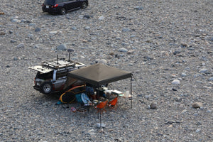 Camp setup with vehicle on a rocky terrain