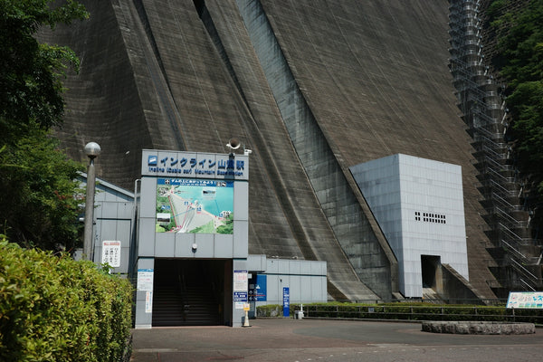 Massive concrete dam structure with an entrance building